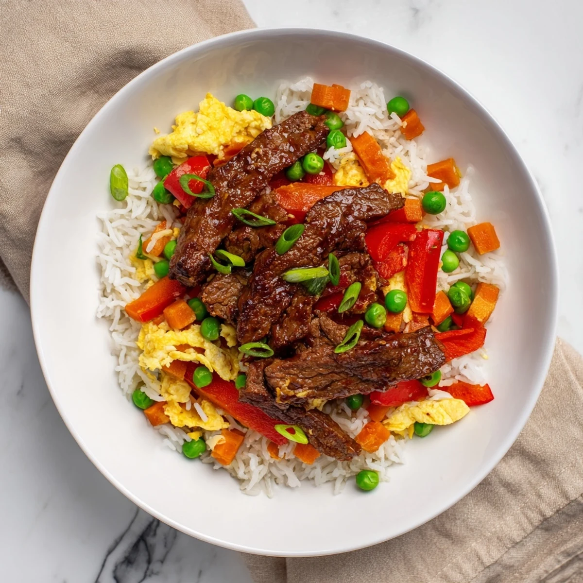 Tender beef and fluffy rice combined in this delectable Beef Fried Rice dish, ready to eat.