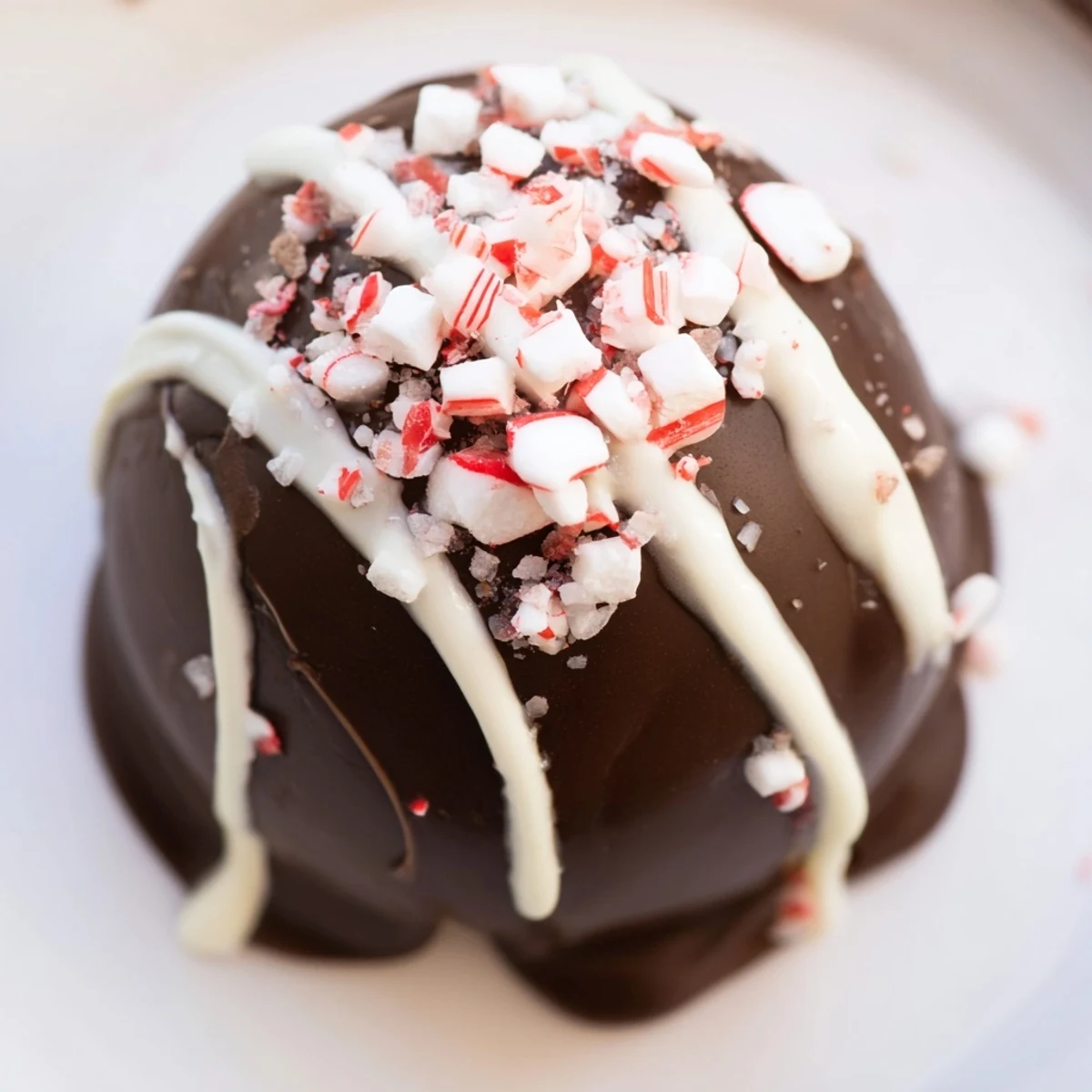 Close-up of Peppermint Hot Cocoa Bombs with Marshmallows melting into steaming milk inside a mug, with mini marshmallows rising and peppermint specks swirling.