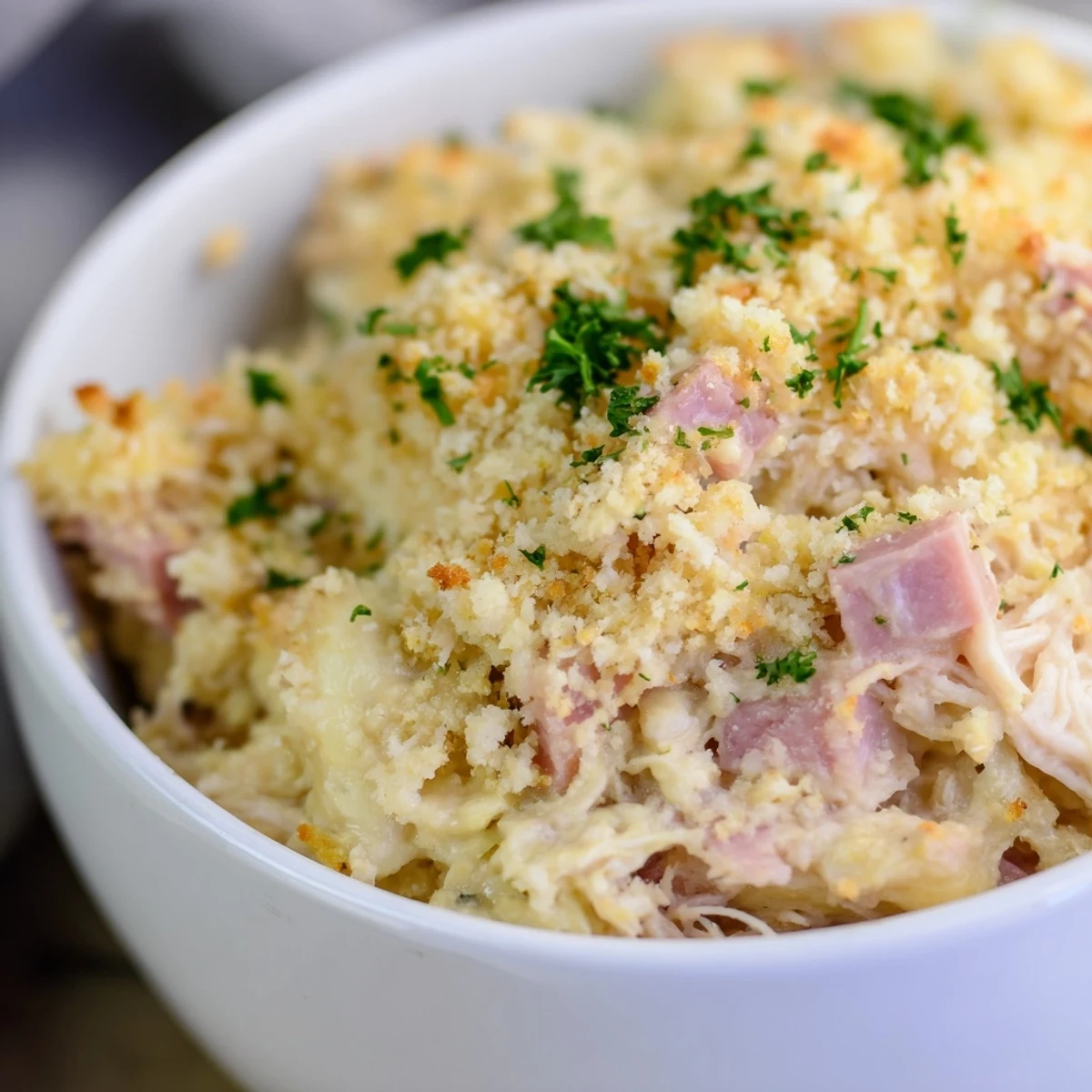 Freshly baked Chicken Cordon Bleu Casserole from the oven with golden crust, served in a family-style dish.