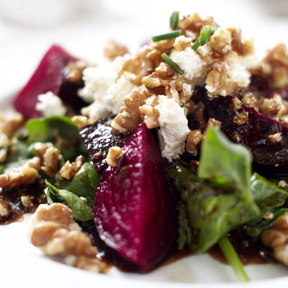 Juicy roasted beet wedges topped with creamy crumbled goat cheese and toasted walnuts on a bed of fresh mixed greens.