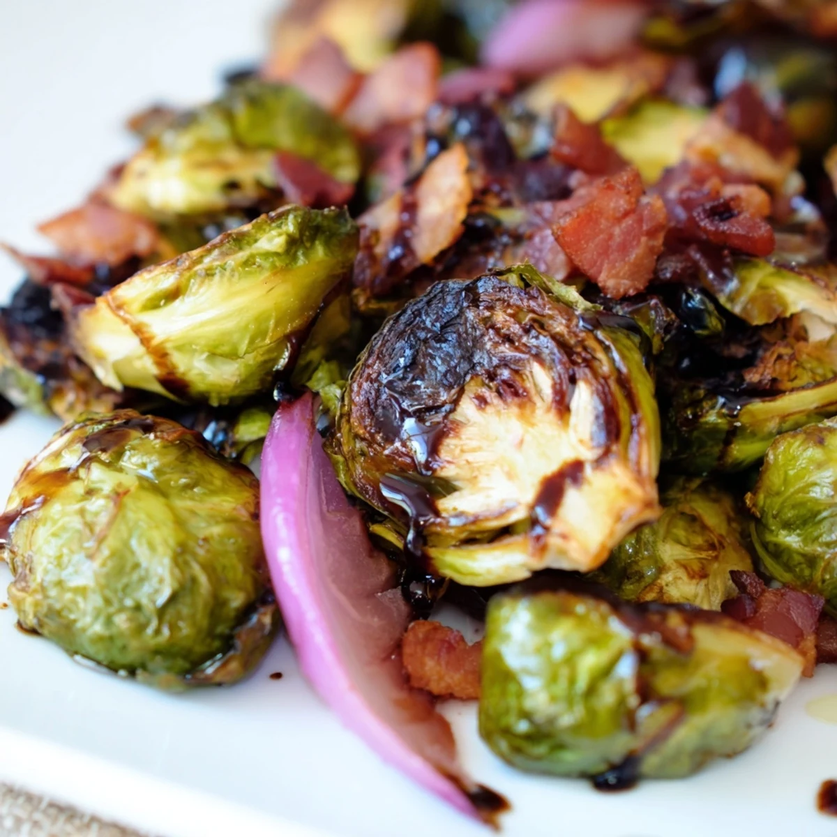 Golden roasted Brussels sprouts with crispy turkey bacon topped with balsamic glaze, served hot on a rustic plate.