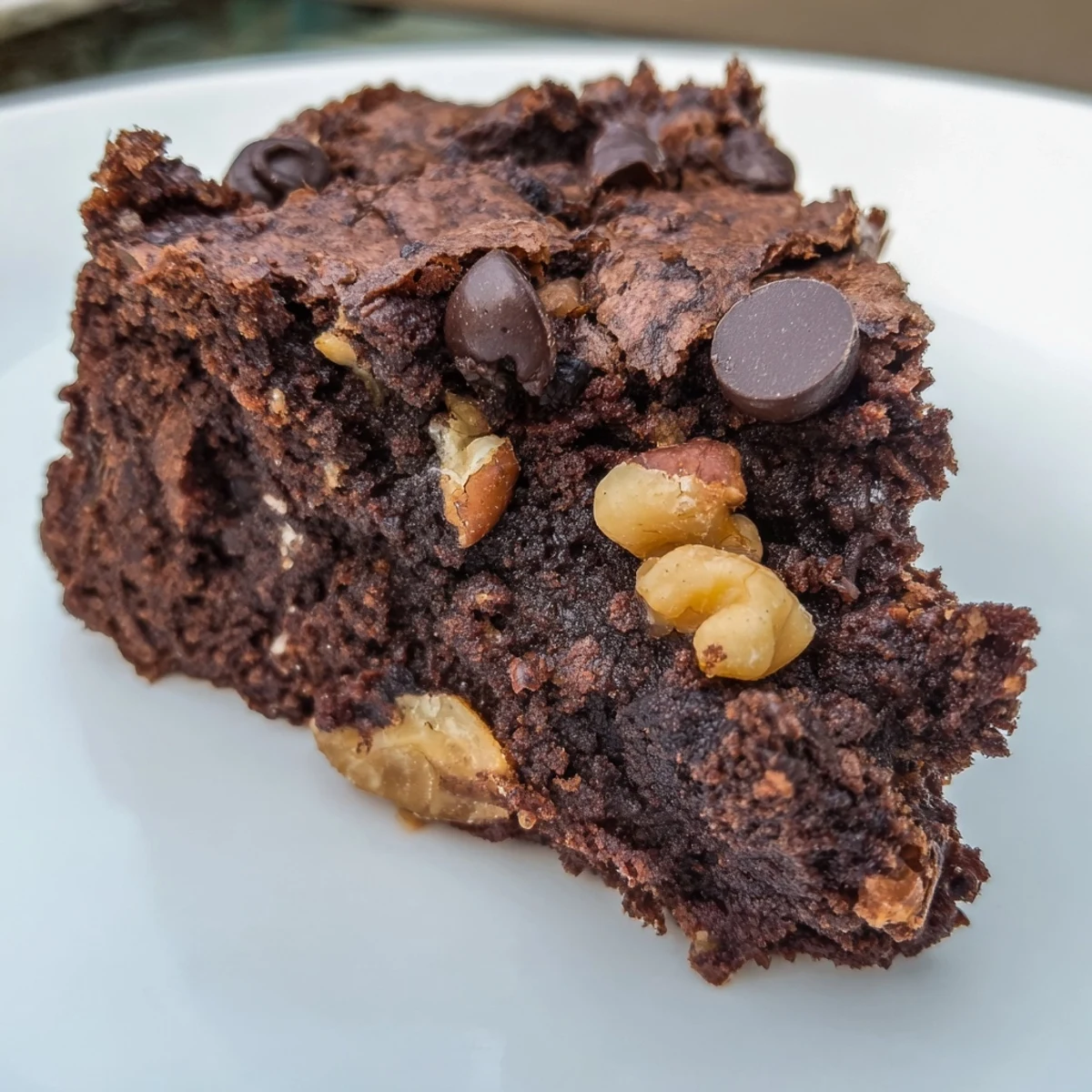 Chocolate Brownie Bites with Nuts arranged on a white plate, showcasing their rich, fudgy texture and crunchy mixed nut toppings.