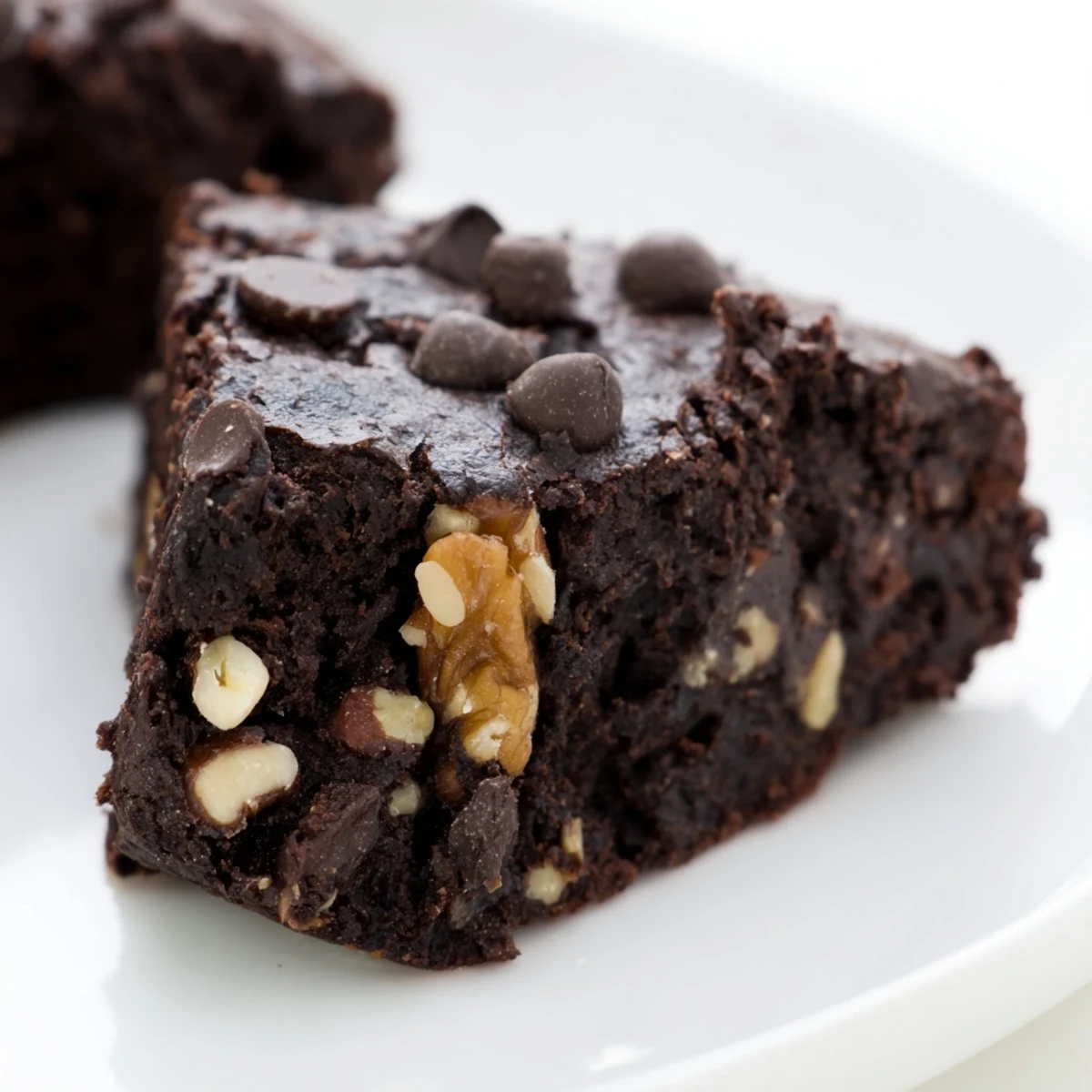 A close-up view of Chocolate Brownie Bites with Nuts highlights the chopped walnuts and pecans baked into the moist, cocoa-rich surface.
