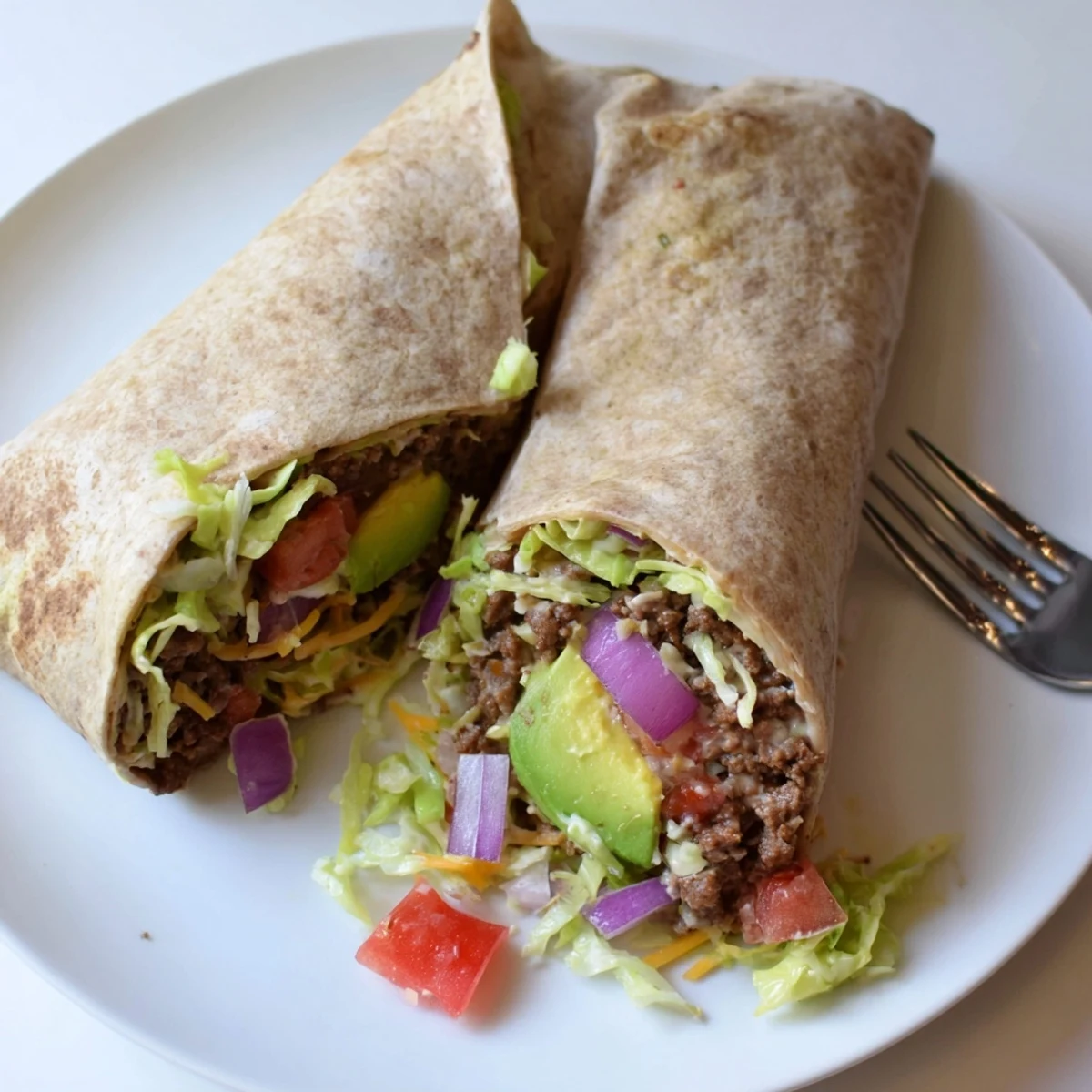 Freshly cooked beef seasoned with cumin and smoked paprika fills this hearty Beef Lunch Wrap Tortilla, layered with crisp lettuce and creamy avocado.  
