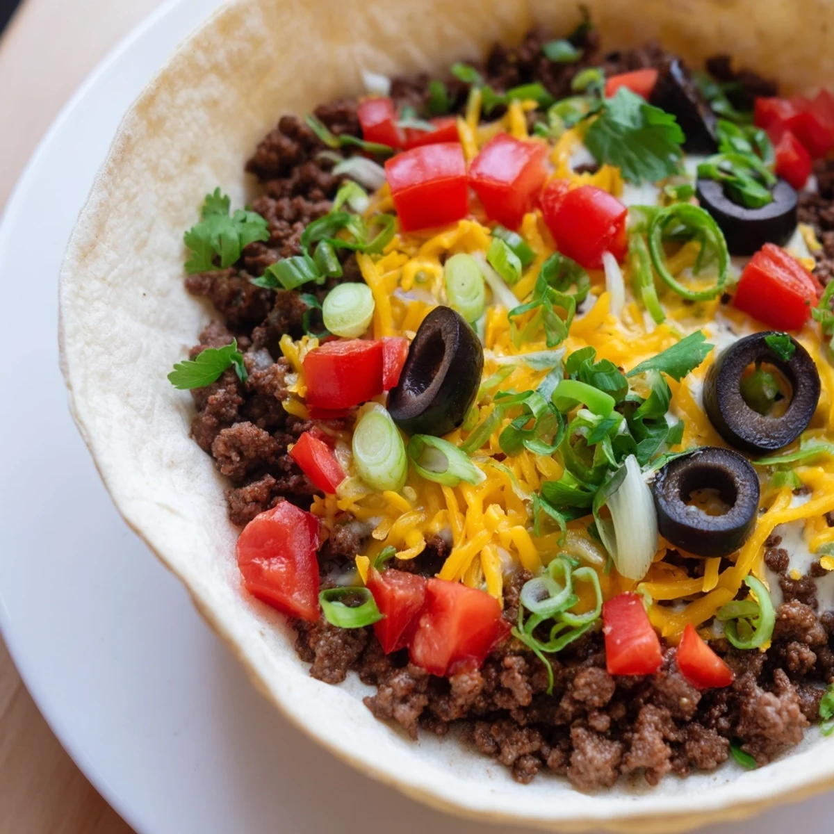 Golden-brown Touchdown Taco Cups stuffed with seasoned ground beef, melty cheddar, and sour cream for an easy game day appetizer.