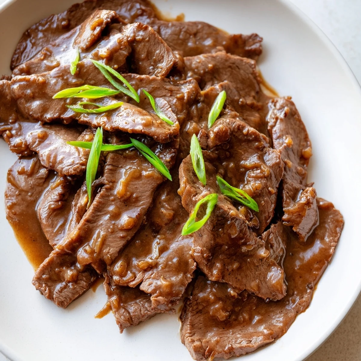 Close-up of Ultimate Slow Cooker Mongolian Beef with rich, sticky sauce and steamed jasmine rice, ideal for busy weeknight dinners.