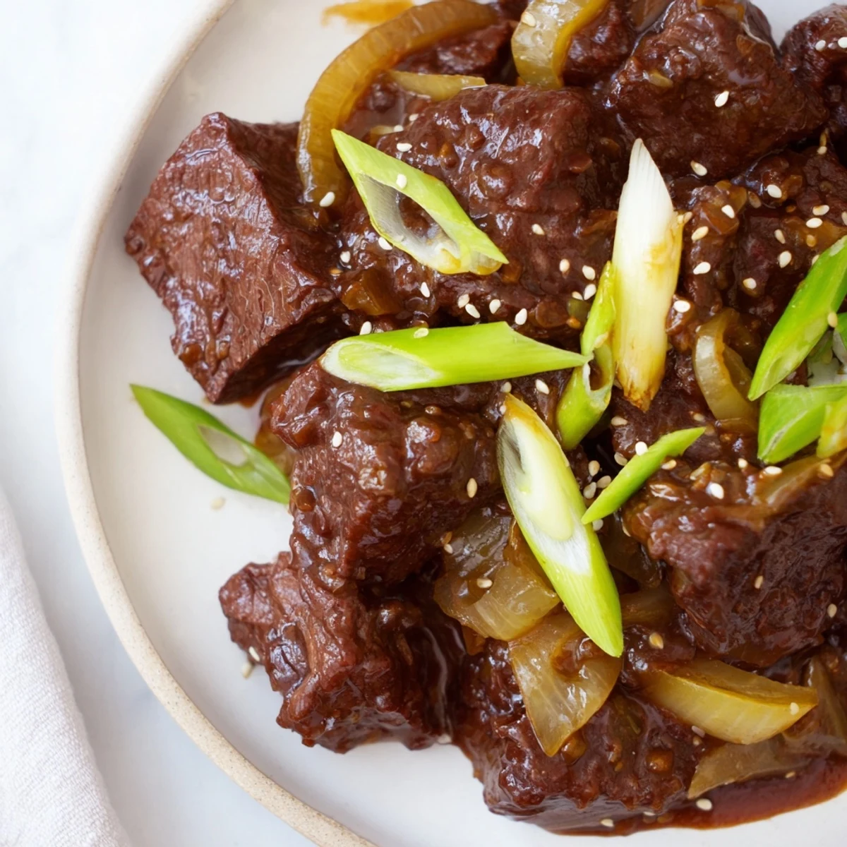 Savory Crock Pot Korean Beef simmers in a slow cooker, tender chunks coated in a glossy, sweet-spicy glaze ready to serve.
