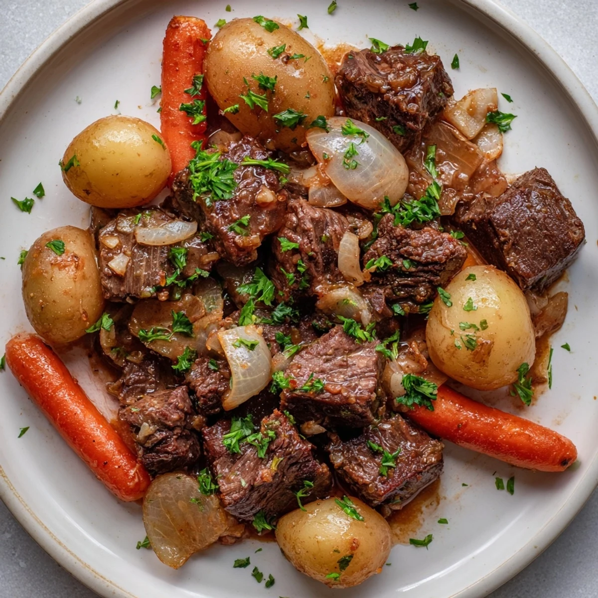 Slow cooker garlic butter beef and potatoes served steaming in a bowl, ready for dinner.