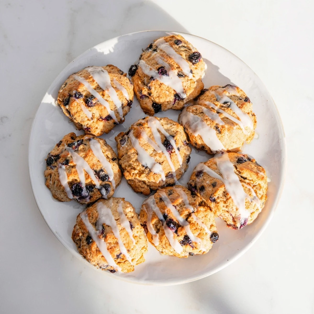 Warm, fluffy Nakishas Blueberry Biscuits served fresh from the oven with a side of butter.
