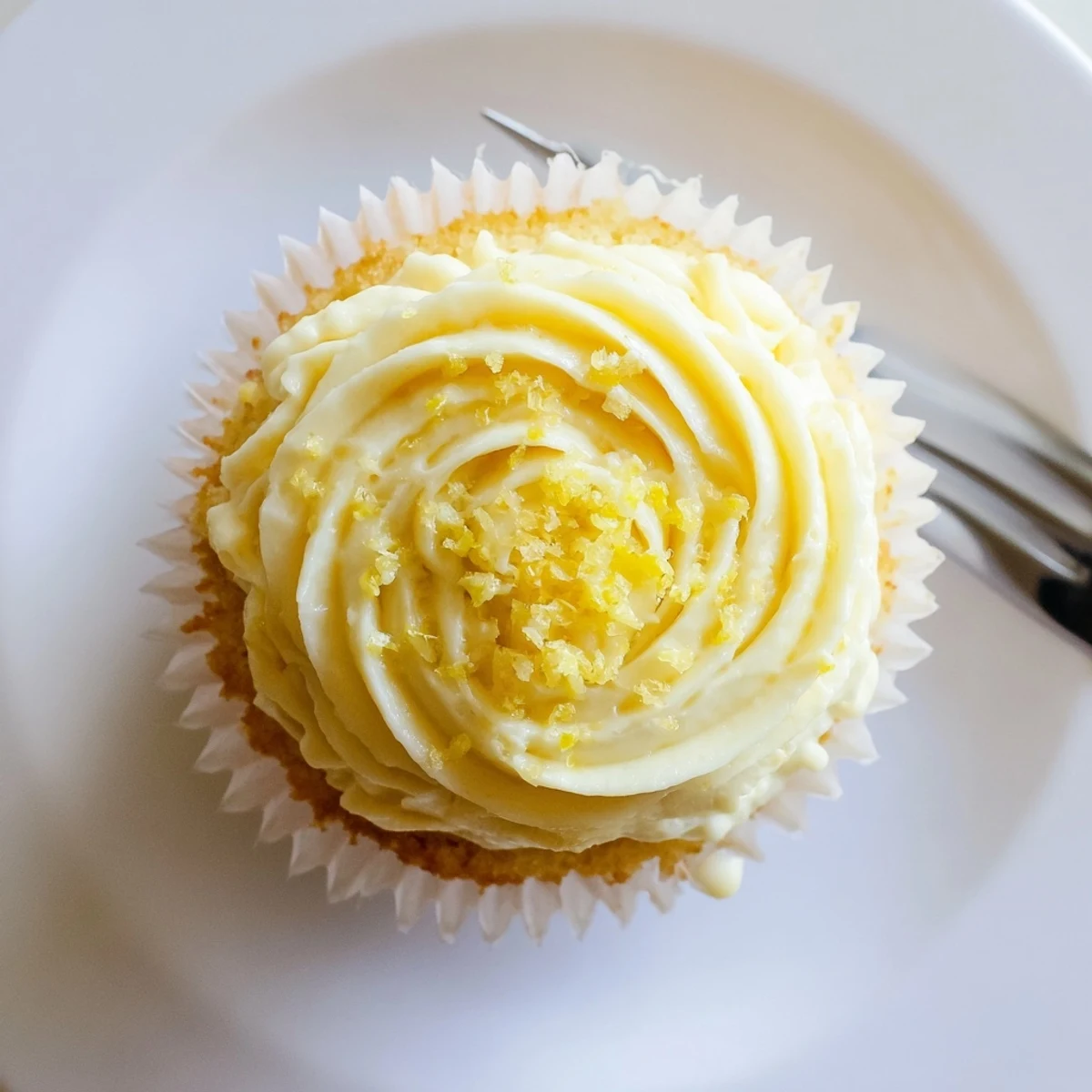 Moist Limoncello Cupcakes with zesty lemon buttercream, paired with a glass of iced limoncello for summer.