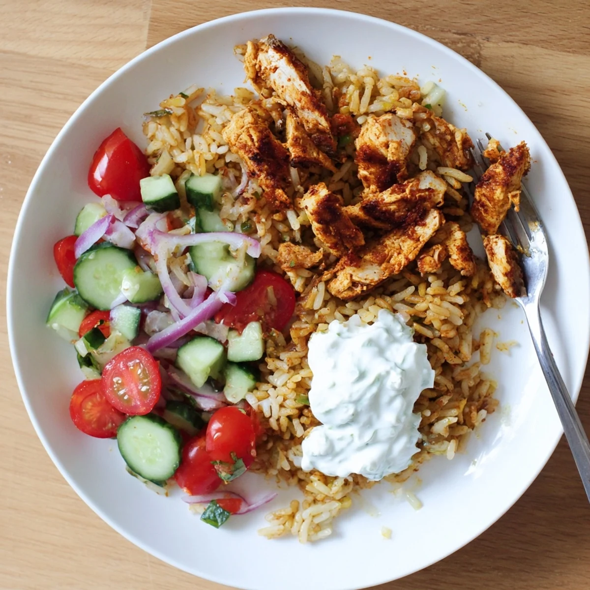 Golden spiced chicken strips and crispy basmati rice tossed with cucumber, tomato, and red onion in a tangy yogurt dressing. 