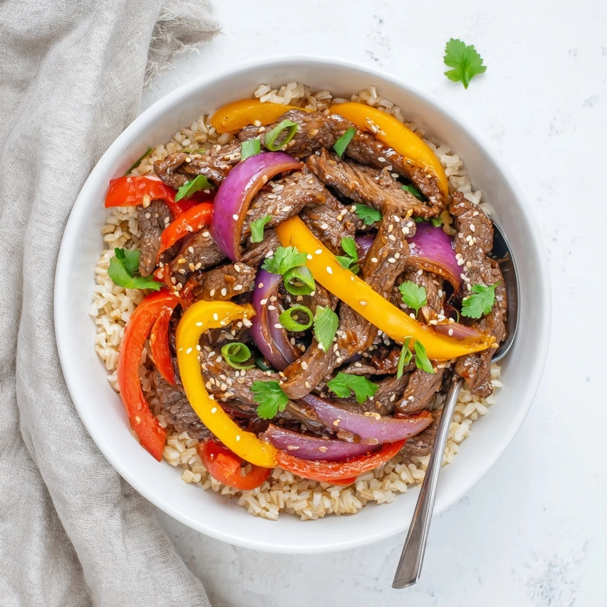 Close-up of Healthy Beef and Pepper Rice Bowl highlighting tender beef strips and crisp, vibrant bell peppers.