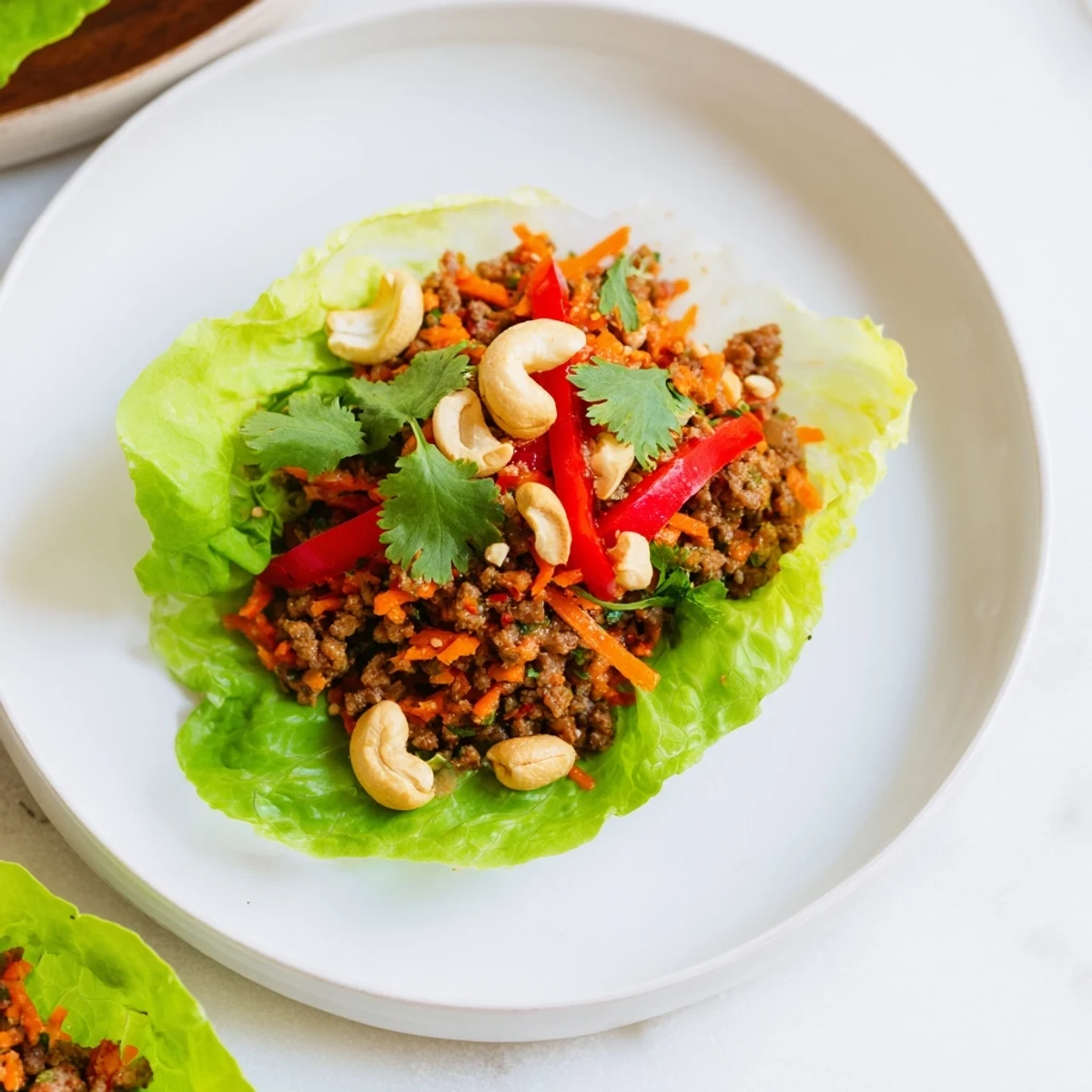 Fresh beef and cashew lettuce cups featuring colorful vegetables and fragrant Asian-inspired seasonings