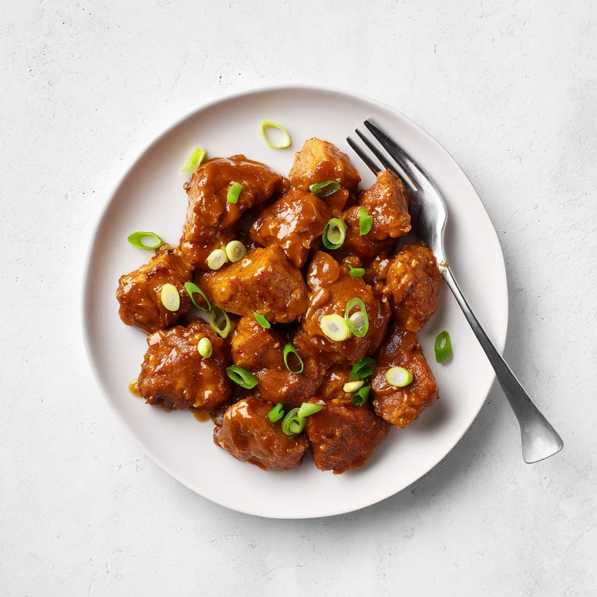 Bite-sized Mongolian chicken coated in a glossy brown sugar glaze served over steamed white rice