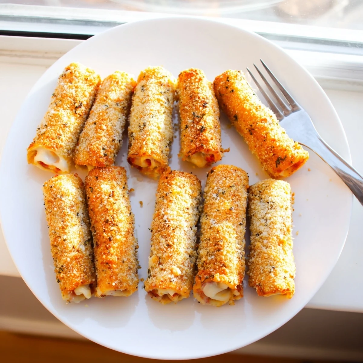Crispy fried ham and cheese appetizers arranged on platter with marinara dipping sauce
