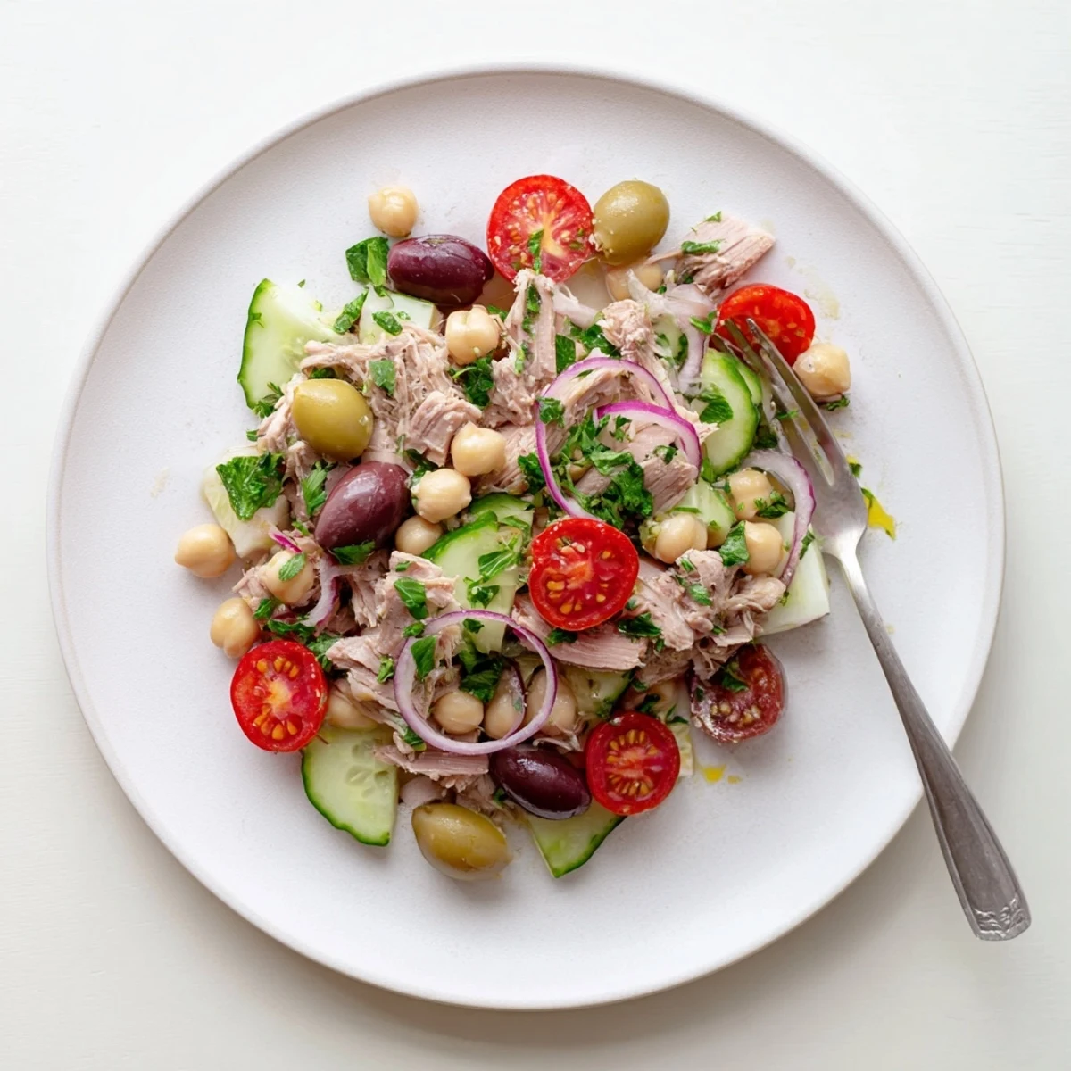 Tuna and Garbanzo Bean Salad plated in white bowl with colorful vegetables