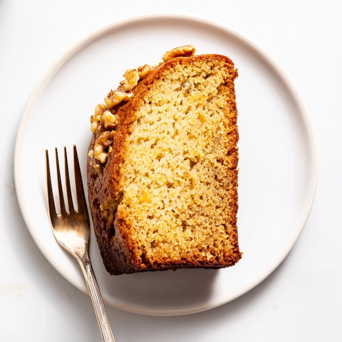 Tender banana bread with sour cream studded with walnuts and ready for breakfast