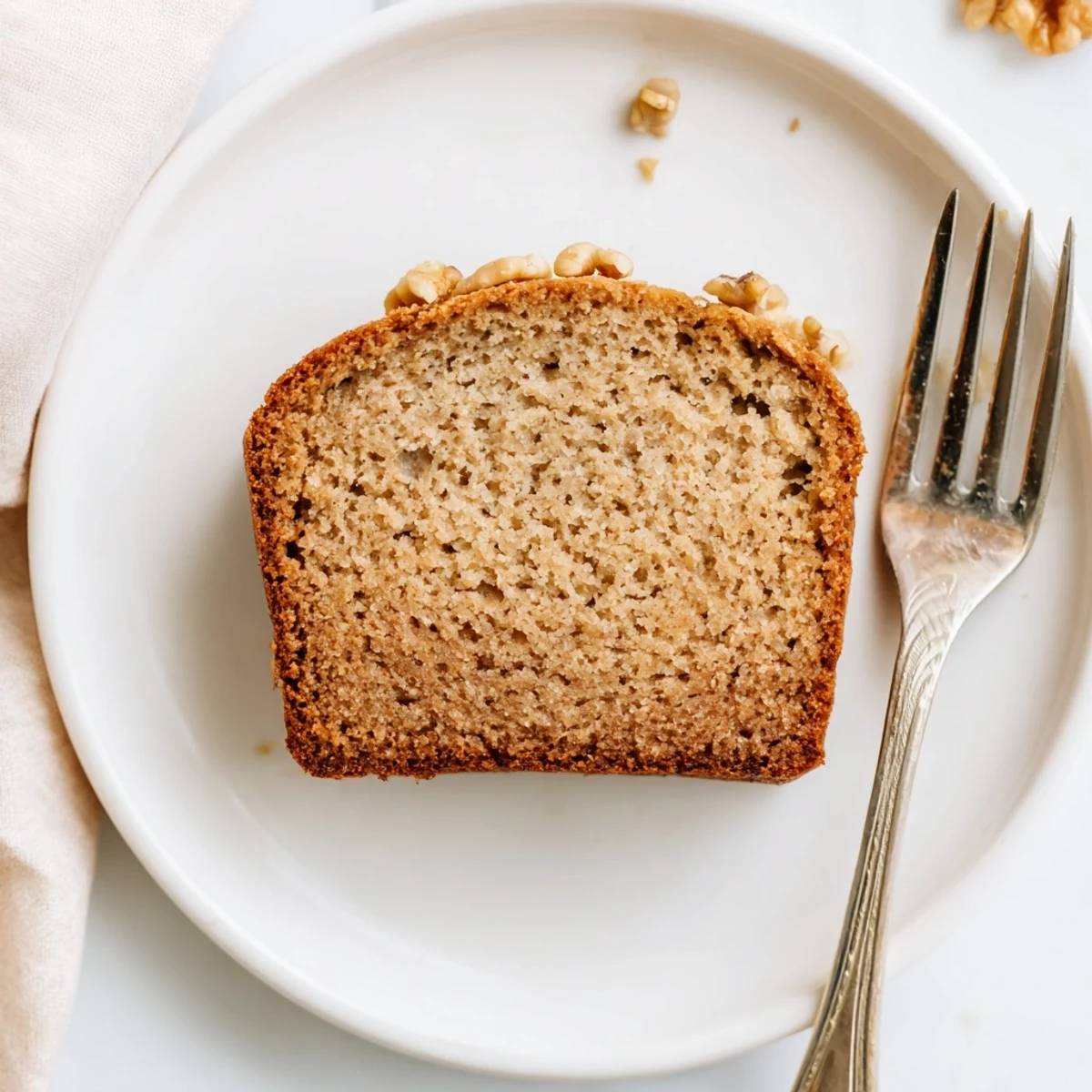 Rich sour cream banana bread loaf cooling on a wire rack with steam rising