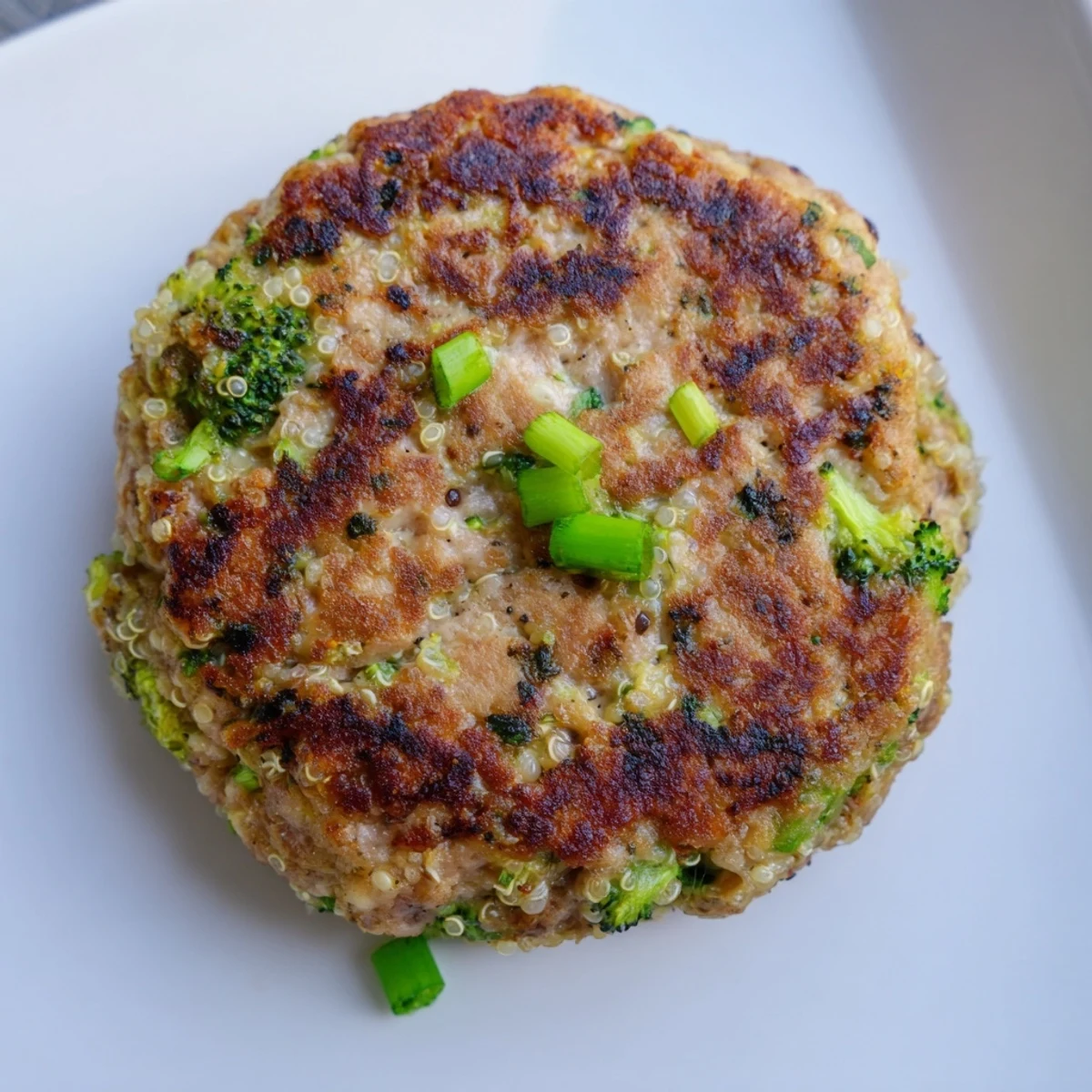 Savory turkey patties with tender broccoli and nutritious quinoa served on gluten-free buns