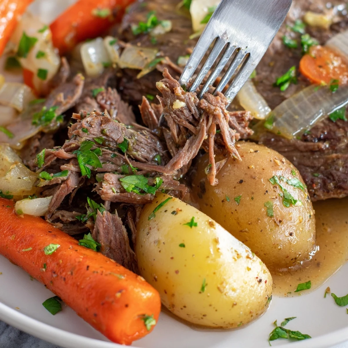 Tender slow cooker steak and potatoes with baby carrots in a rich beef broth
