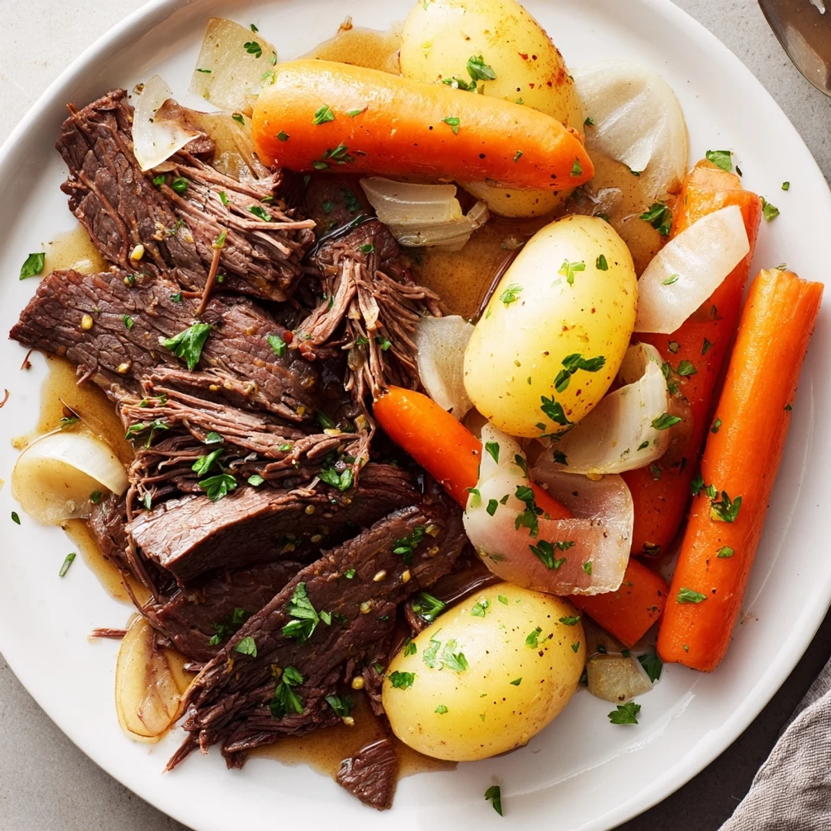 Golden seared beef steaks nestled with buttery potatoes and vegetables in a slow cooker