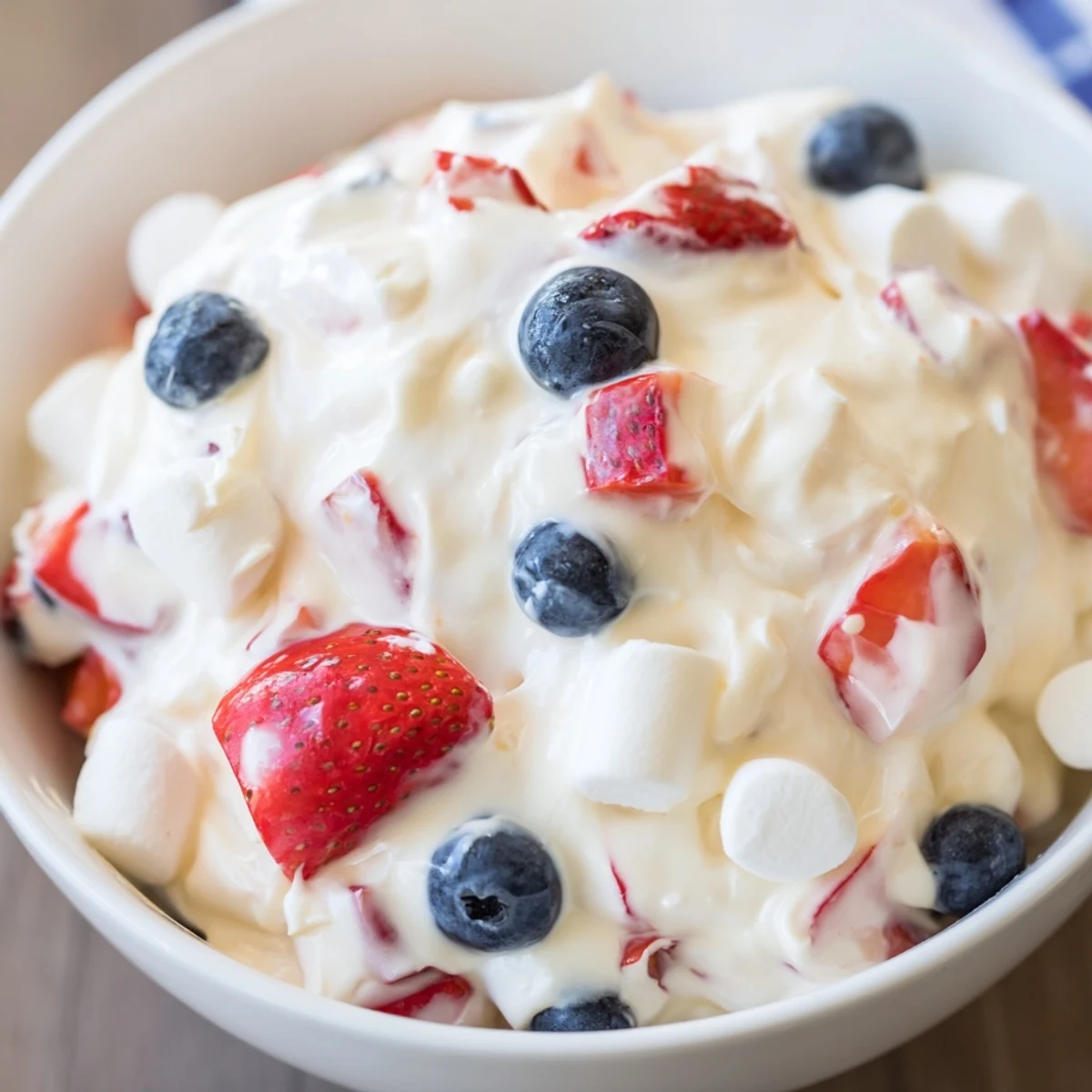 Fluffy Red White Blue Cheesecake Salad studded with juicy berries and sweet marshmallows