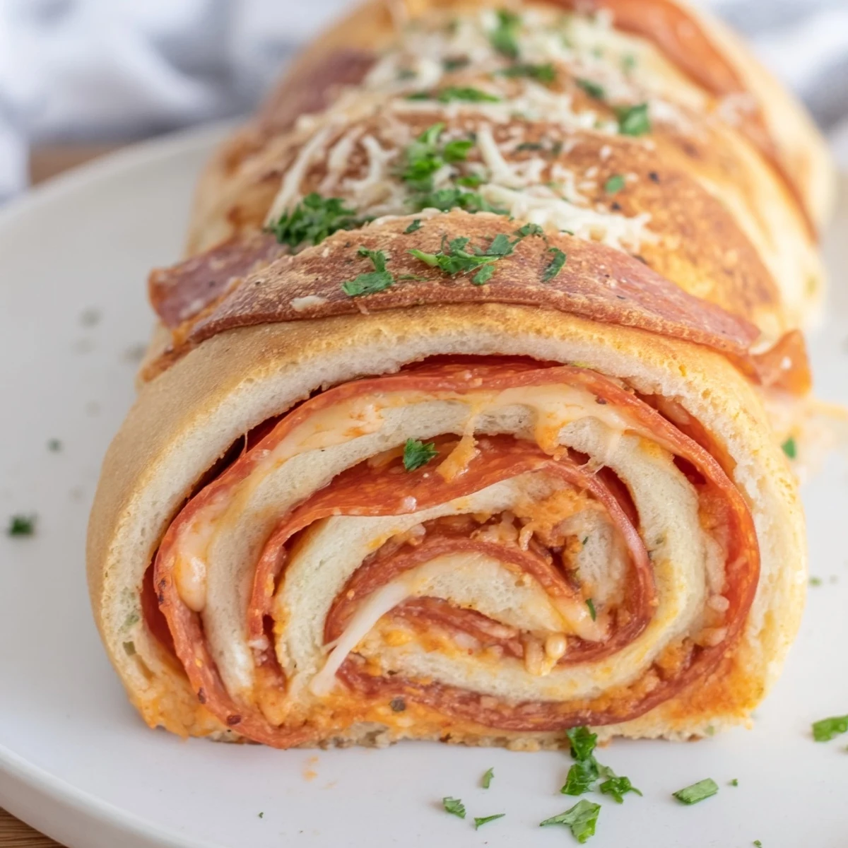 Gooey pepperoni pizza roll breadsticks brushed with garlic butter and sprinkled with parsley