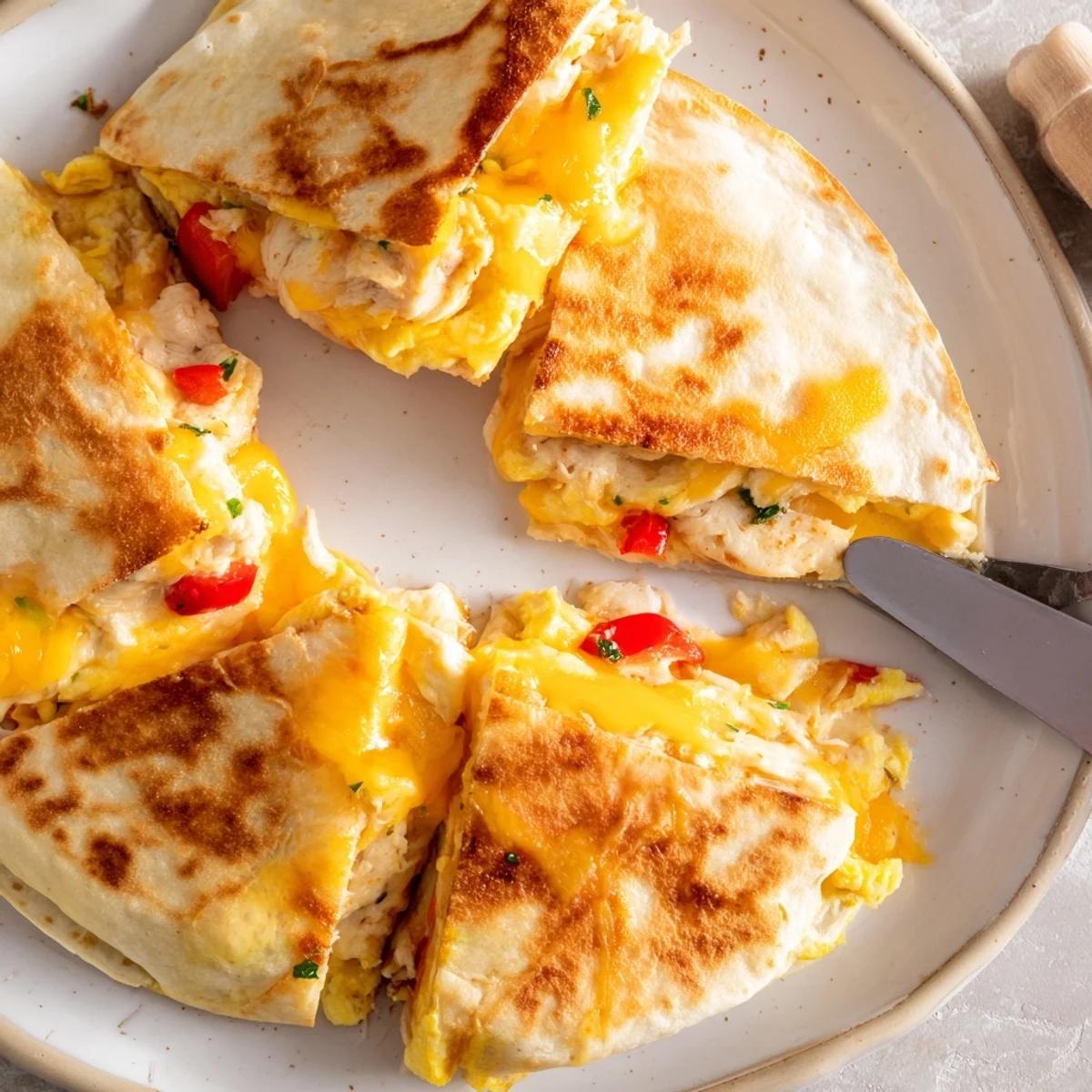Golden, crispy Chicken Breakfast Quesadilla filled with scrambled eggs, melty cheddar