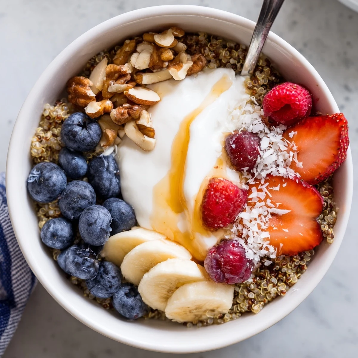 Topped with creamy yogurt and berries, Quinoa Breakfast Bowl ready to eat