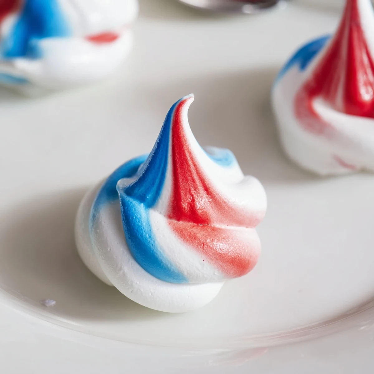 Serve Patriotic Meringue Kisses piled on dessert platter for Fourth of July
