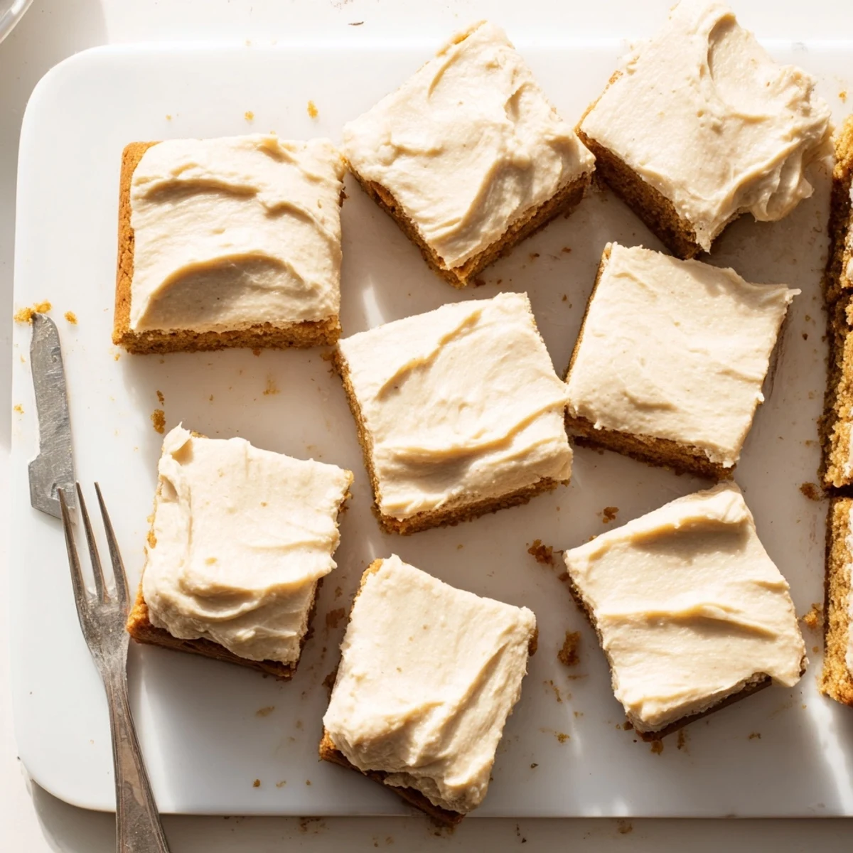Fudgy banana bread brownies with caramelized brown butter frosting on a white plate