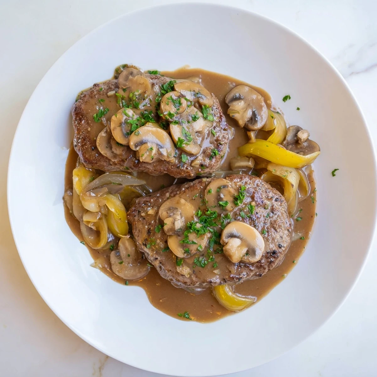 Tender beef cube steaks covered in creamy southern gravy with sautéed onions and mushrooms