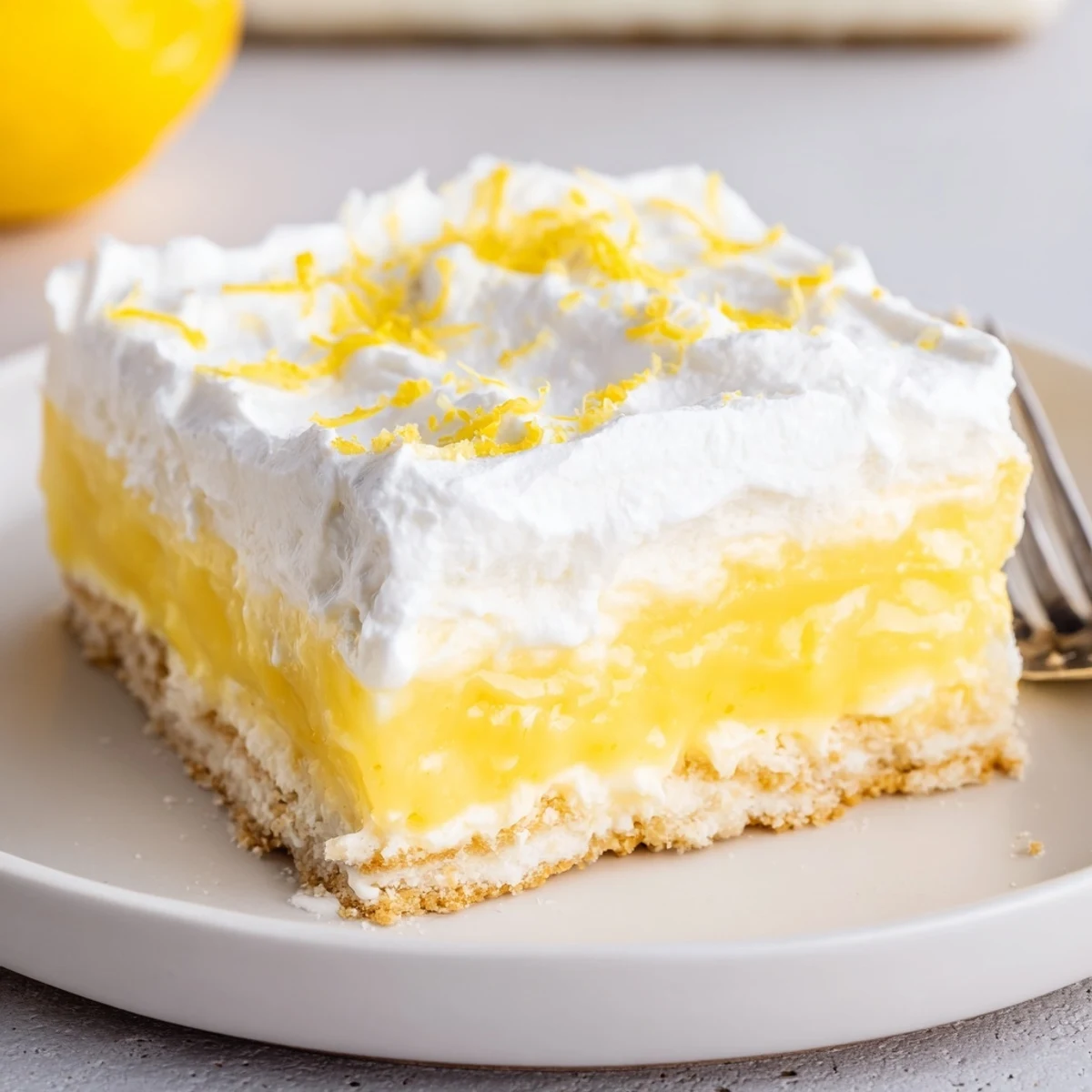 Chilled Lemon Lush Cake with bright lemon zest sparkle and buttery crust