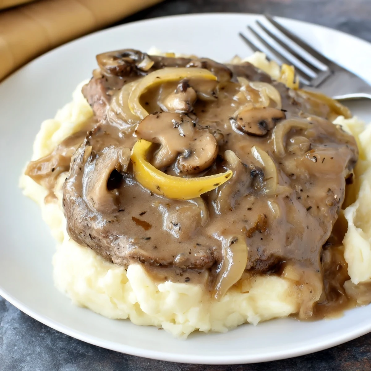 Country Style Smothered Cube Steak Recipe with browned steaks and savory mushroom-onion gravy