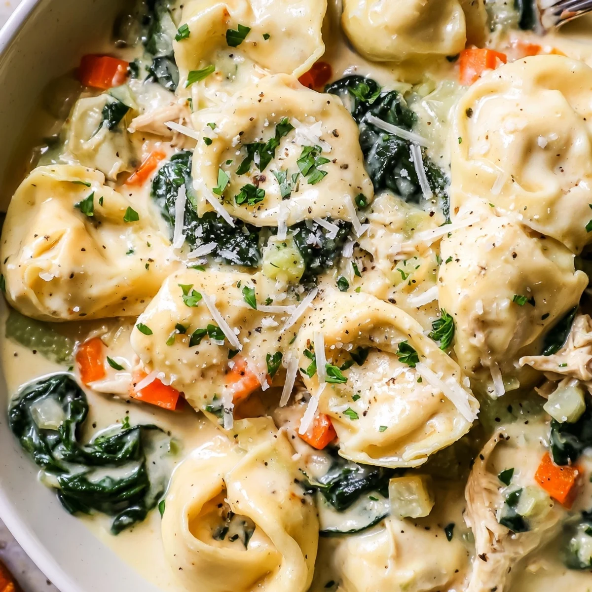 Creamy Crockpot Chicken Tortellini with tender vegetables in a rich, golden sauce