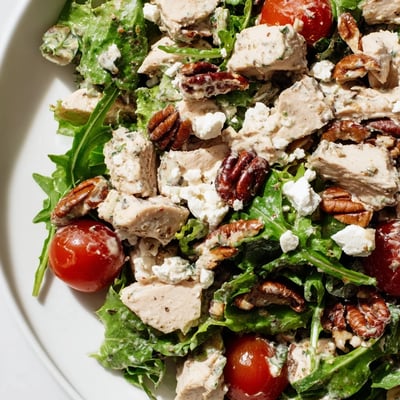 A creamy homemade dressing coats tender diced chicken in this Chicken Pecan Salad with Dressing, topped with crumbled feta.